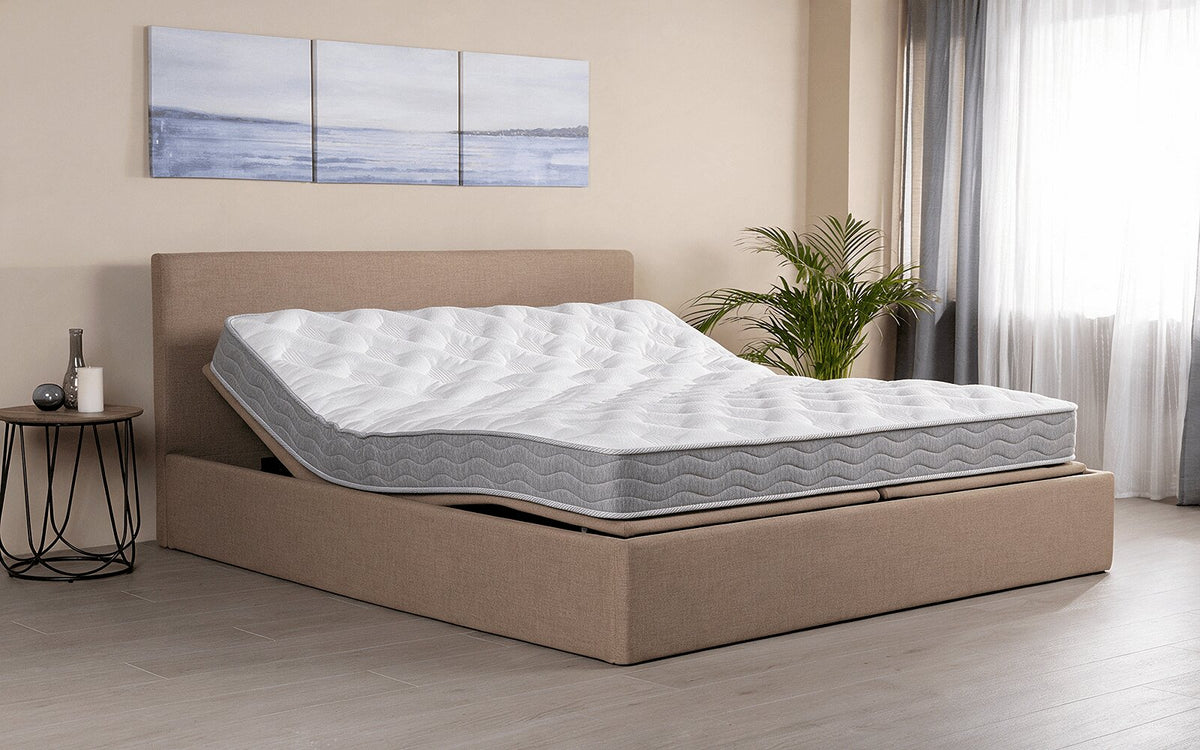 Interior lifestyle view of the Exp Technology Flexy Spring mattress with knitted fabric and quilted detailing